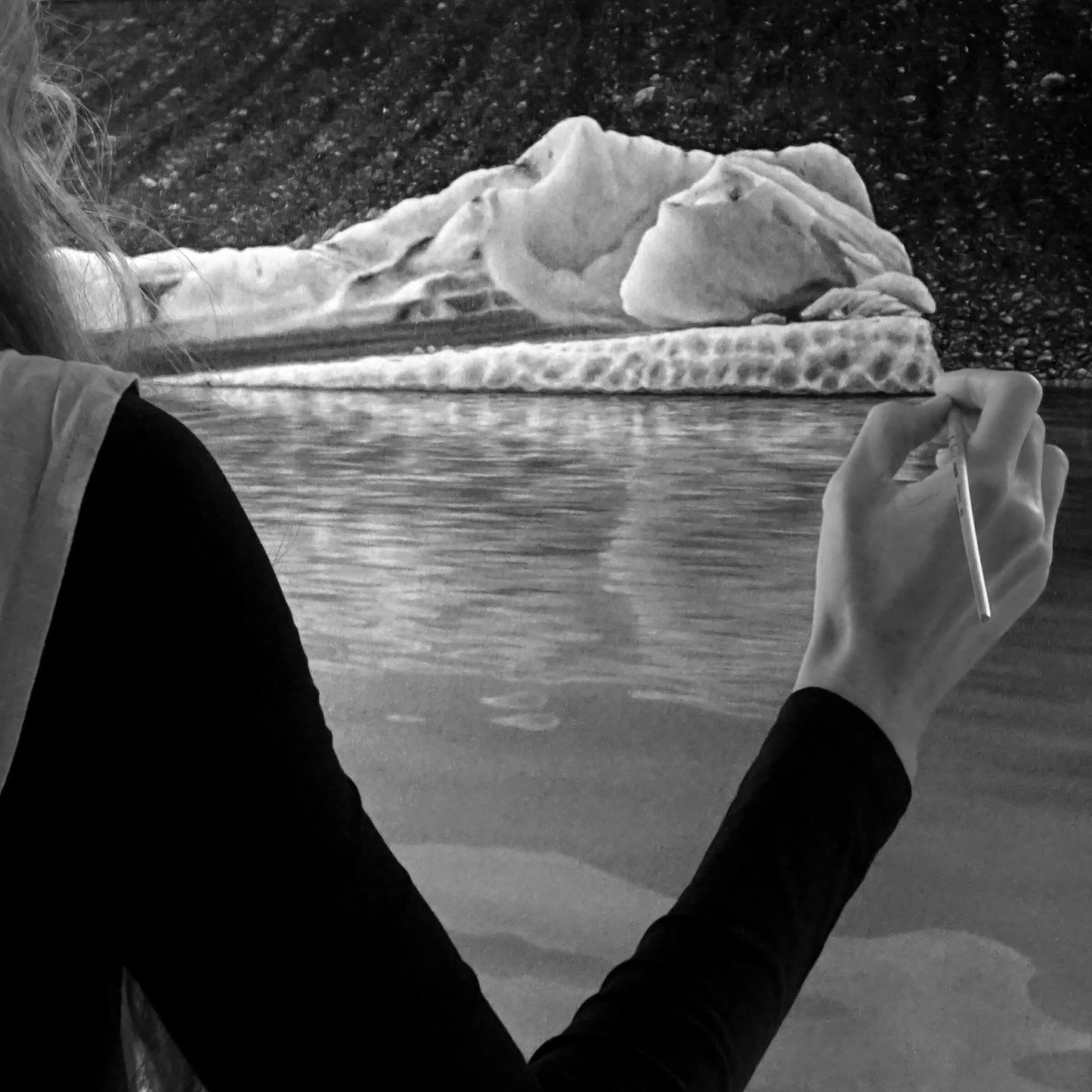 Australian artist, Hayley Byron, painting an iceberg in oil on canvas. This image features the artist painting on the canvas with a paintbrush. The title of this work is Chrysocolla.