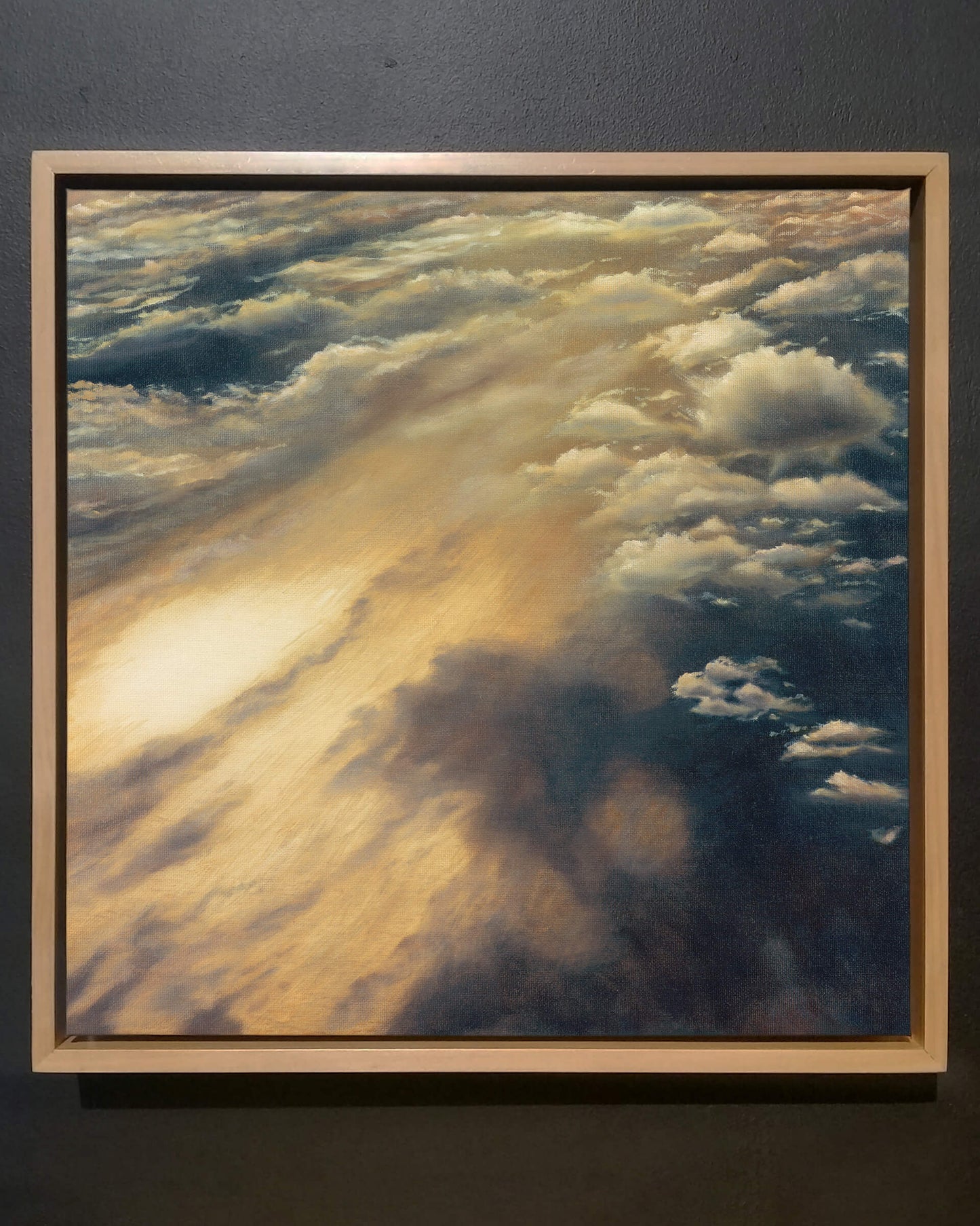 Original art, titled Cloudland, painted in oil on canvas, by Australian artist, Hayley Byron. The painting is a depiction of a cloudscape, from an aerial viewpoint. This image features the artwork on a wall in a custom-made Tasmanian oak frame.