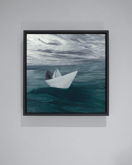 Original art, titled Hope, painted in water mixable oil on canvas, by Australian artist, Hayley Byron. The painting is a depiction of a paper boat, floating in the ocean, with clouds in the background. This image features the artwork on a wall in a custom-made frame.