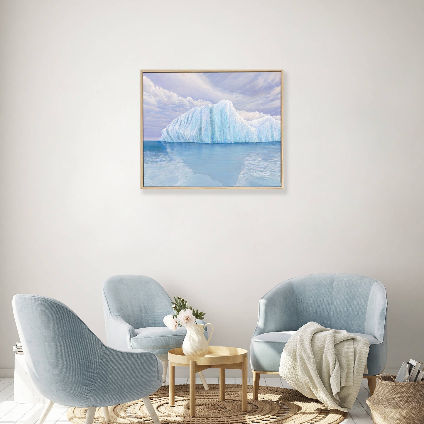 Original art, titled Ametrine, painted in oil on linen, by Australian artist, Hayley Byron. The painting is a depiction of an iceberg, with clouds in the background, and water in the foreground. This image features the artwork in-situ, on a wall in an interior living room.