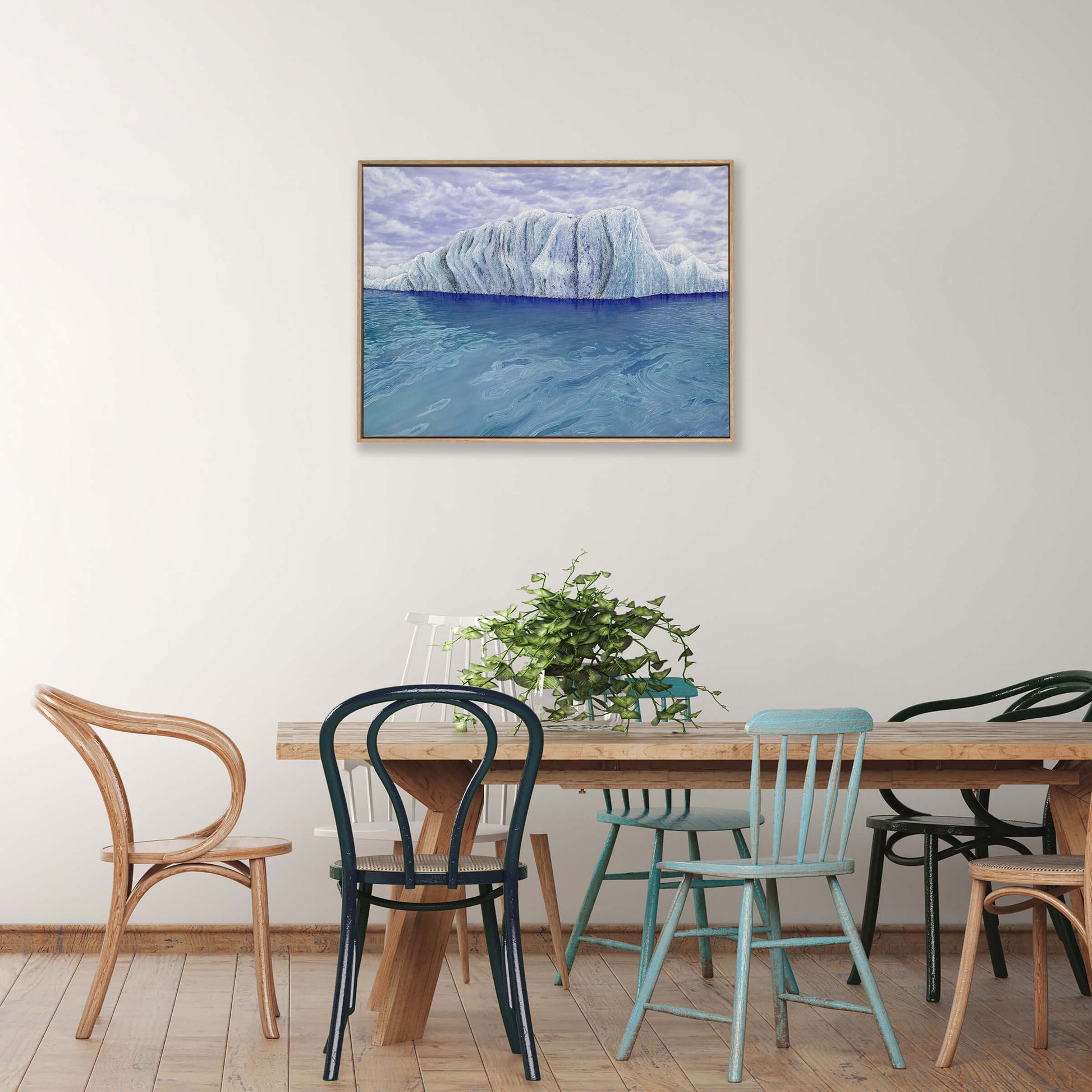 Original art, titled Ammonite, painted in oil on canvas, by Australian artist, Hayley Byron. The painting is a depiction of an iceberg, with clouds in the background, and water in the foreground. This image features the artwork in-situ, on a wall in an interior living room.