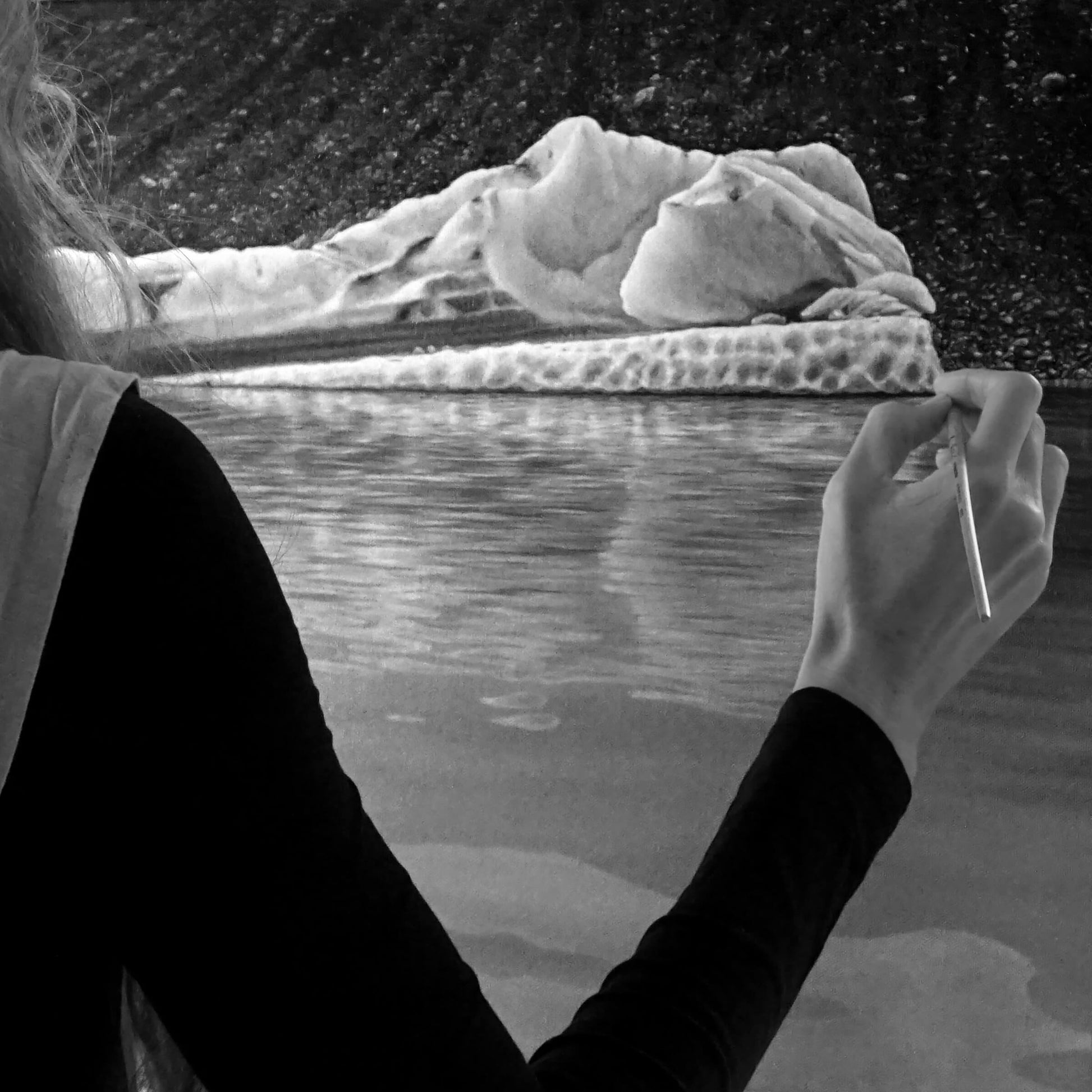 Australian artist, Hayley Byron, painting an iceberg in oil on canvas. This image features the artist painting on the canvas with a paintbrush. The title of this work is Chrysocolla.