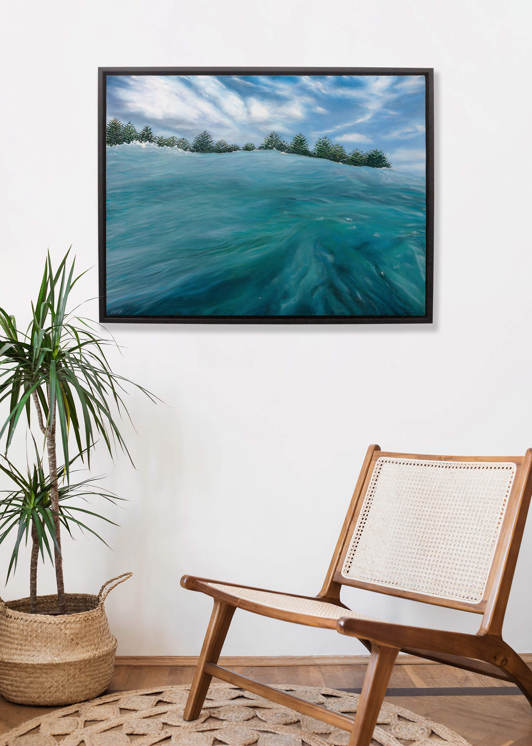 Original art, titled Playground, painted in oil on canvas, by Australian artist, Hayley Byron. The painting is a depiction of being in the ocean at Burleigh Heads, from the viewpoint of sitting out the back, with Norfolk Pine trees in the distance. This image features the artwork in-situ, on a wall in an interior living room.