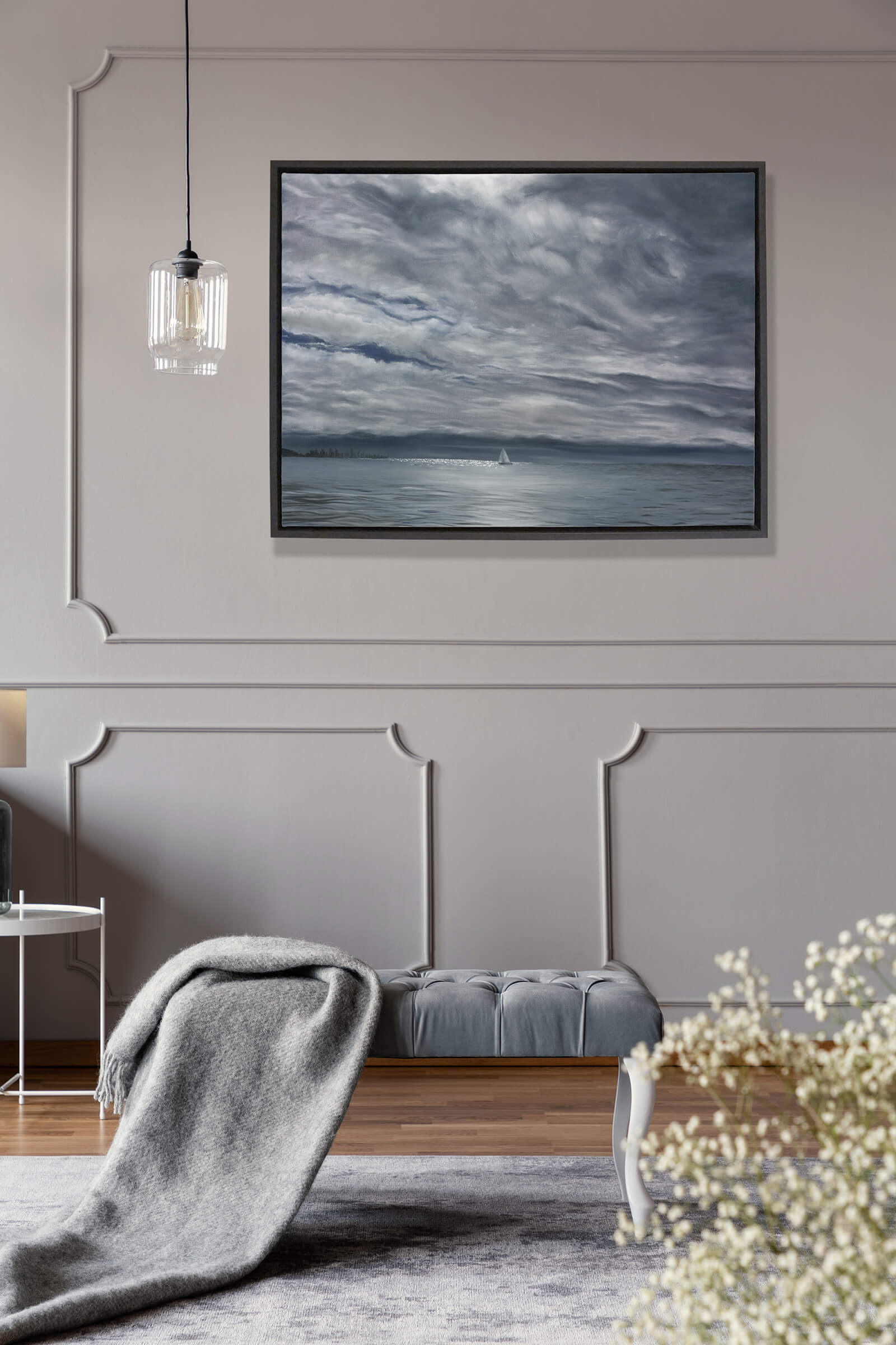 Original art, titled Yesterday, painted in oil on canvas, by Australian artist, Hayley Byron. The painting is a depiction of a ship sailing on the ocean at Burleigh Heads, in a rain storm, with high-rise buildings in the distance. This image features the artwork in-situ, on a wall in an interior living room.
