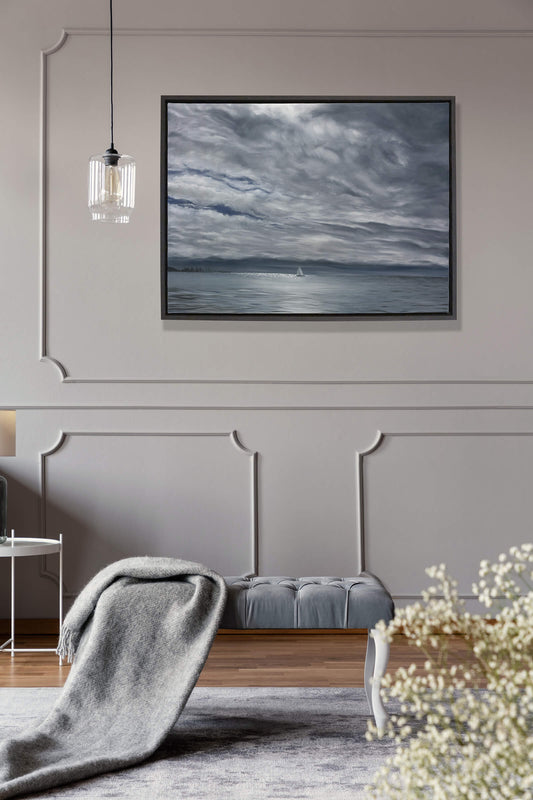 Original art, titled Yesterday, painted in oil on canvas, by Australian artist, Hayley Byron. The painting is a depiction of a ship sailing on the ocean at Burleigh Heads, in a rain storm, with high-rise buildings in the distance. This image features the artwork in-situ, on a wall in an interior living room.